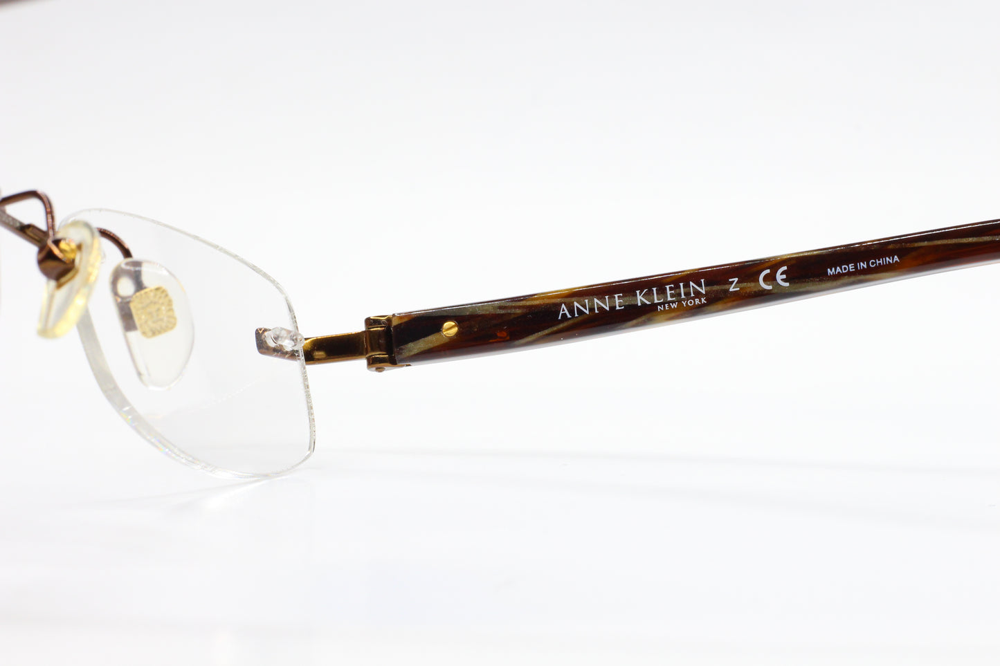Anne Klein AK9121 571 Bronze Gold Tortoise Rimless Luxury Eyeglasses Optical Frames ABC Optical Eyeglasses
