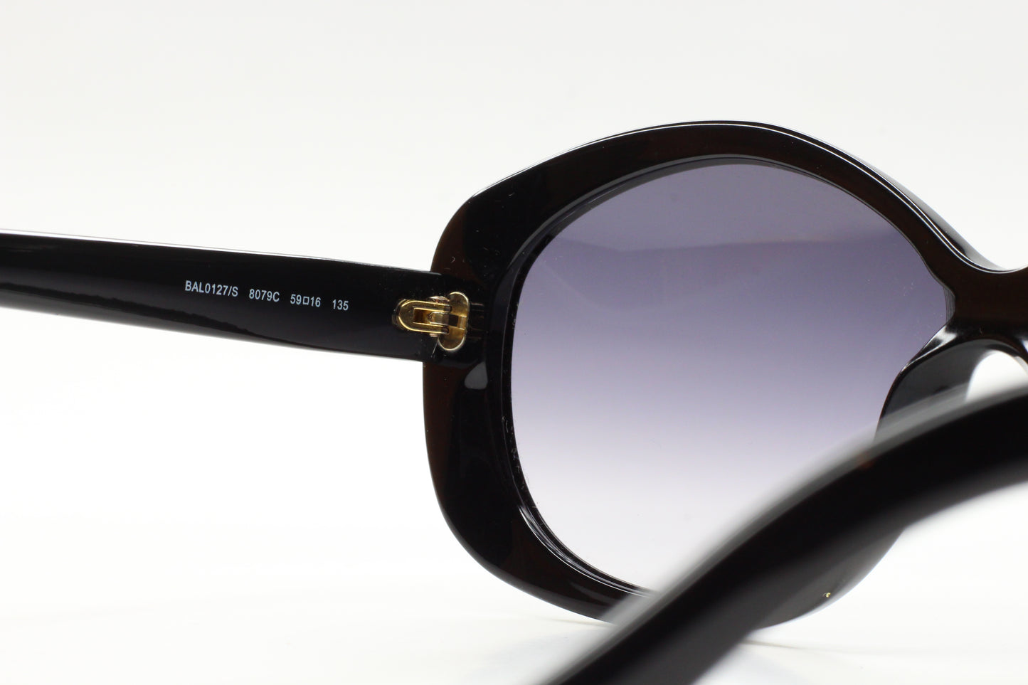 Close-up of black Balenciaga BAL0127S sunglasses online showing frame details and gradient lenses
