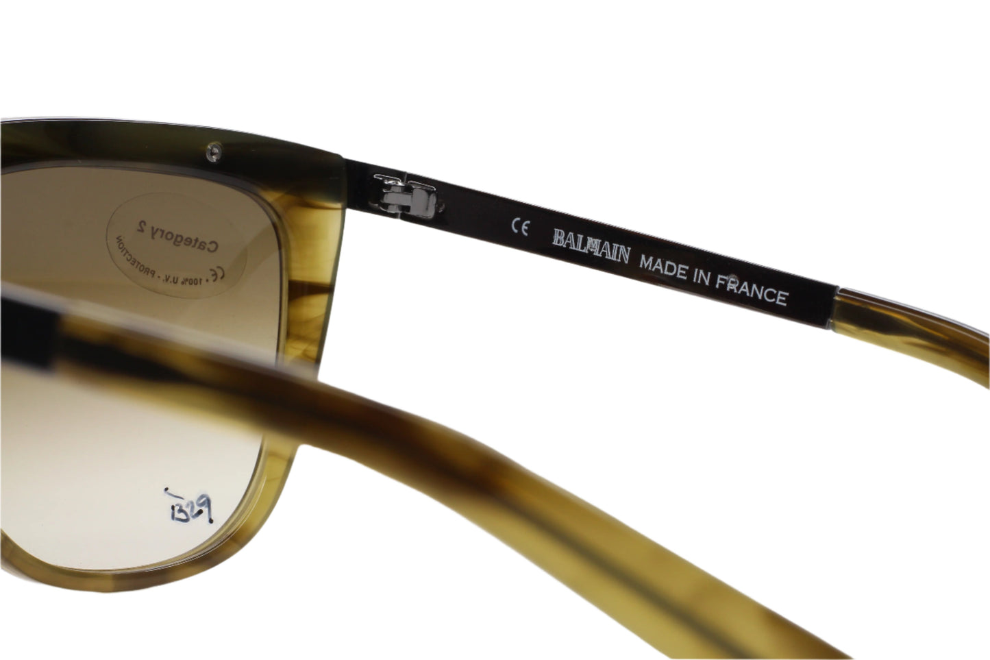 Close-up of Balmain Paris khaki horn sunglasses showing frame details and branding by ABC Optical