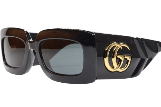 Black Gucci GG0811S sunglasses with thick frames and gold double G logo on the temples