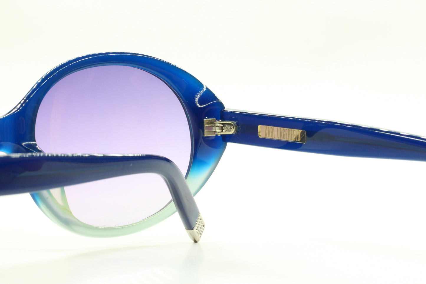 Close-up of Karl Lagerfeld blue gradient sunglasses showcasing round frames and blue temples