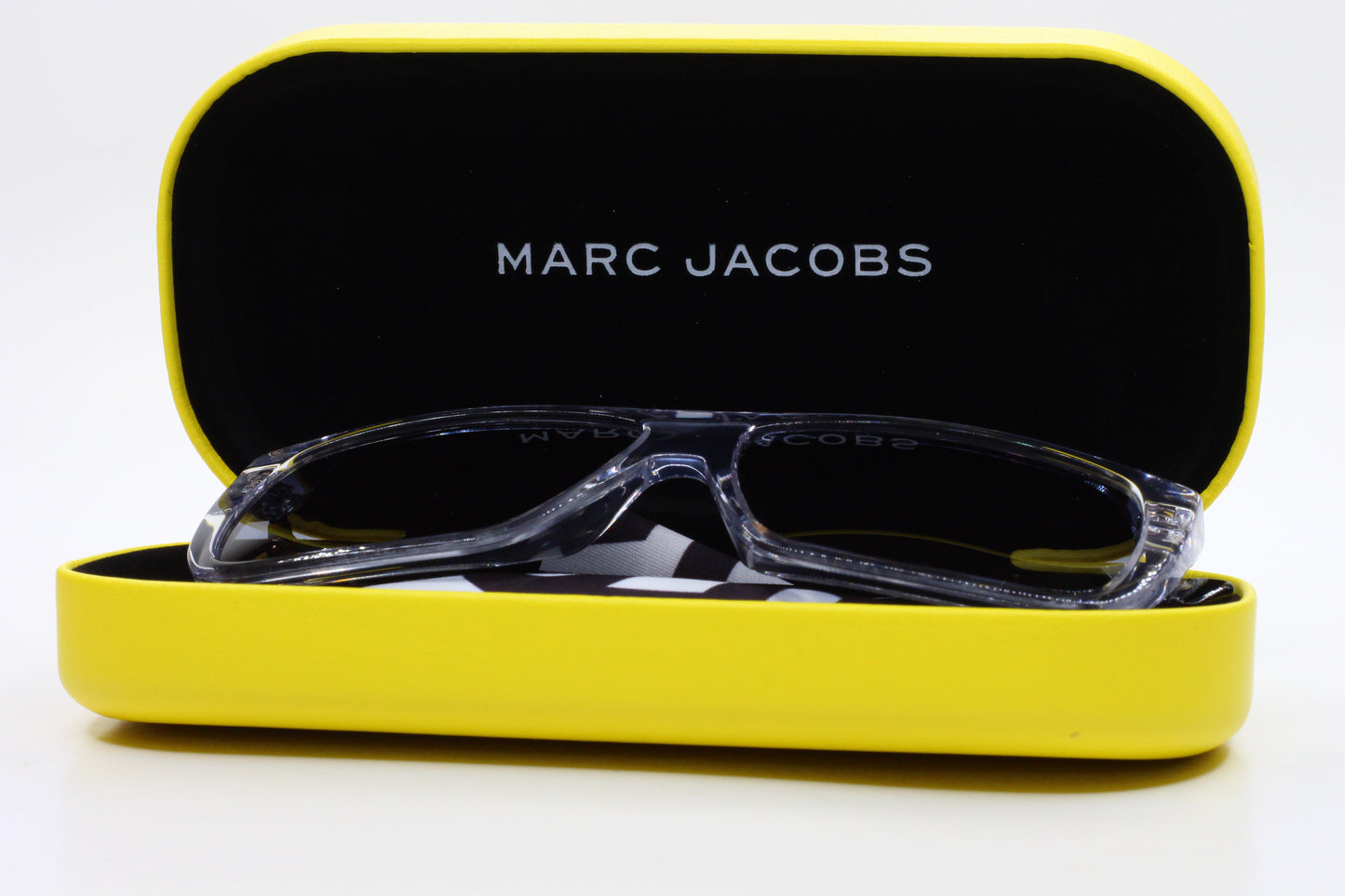Luxury clear frame sunglasses by ABC Optical displayed in a yellow Marc Jacobs case