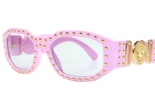 Pink sunglasses with gold accents on a white background