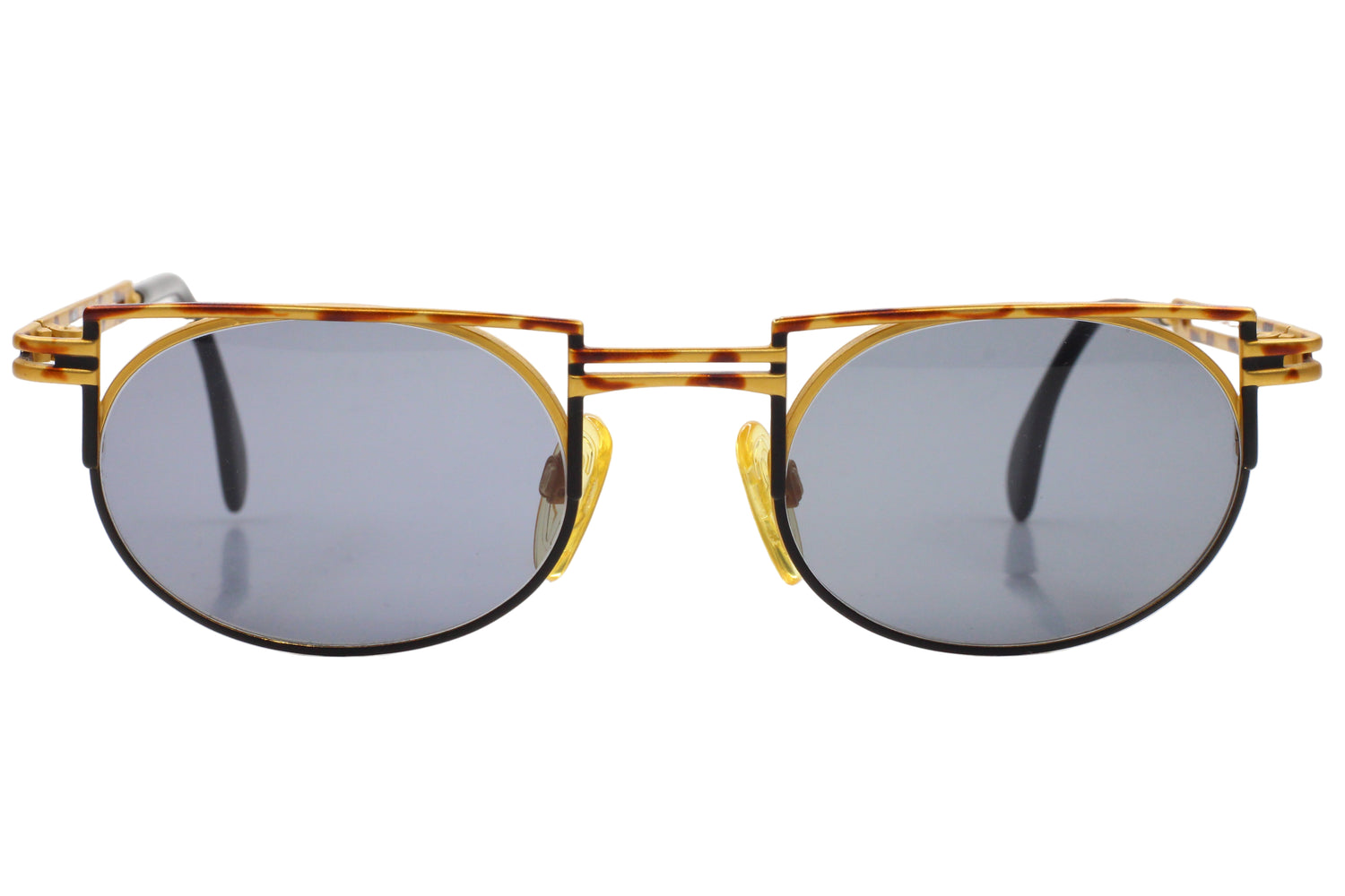 Sunglasses with gold frame and dark lenses on a white background