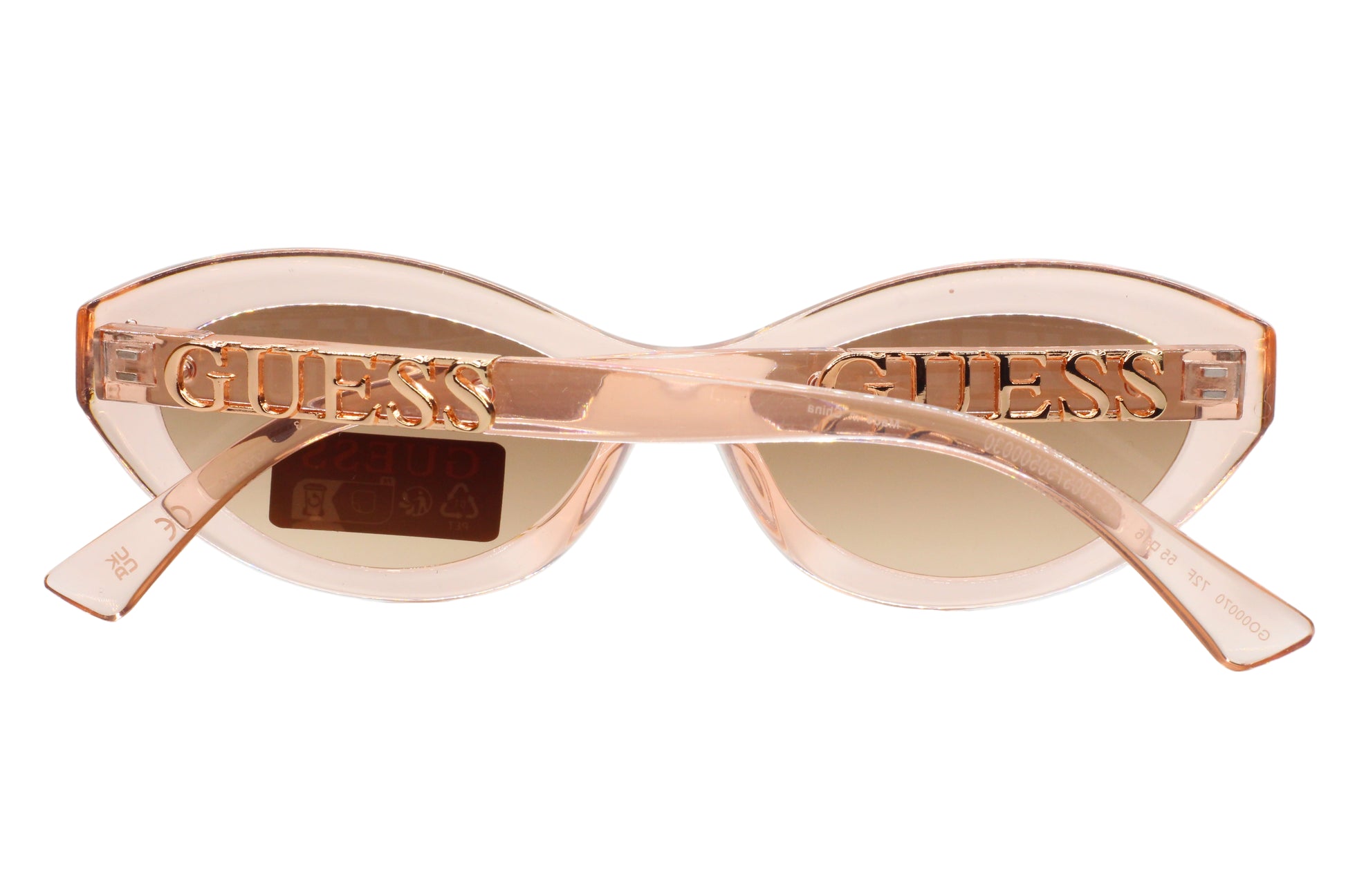 Guess sunglasses with a rose gold frame on a white  background
