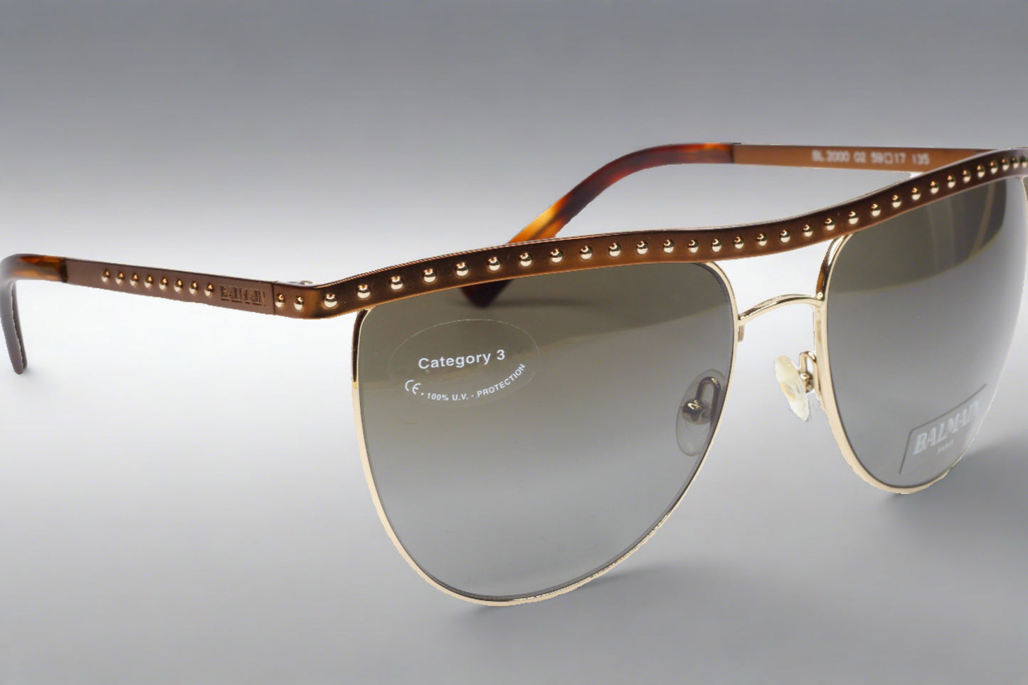 Balmain BL2000 02 sunglasses for sale with brown studded frames and gray lenses by ABC Optical