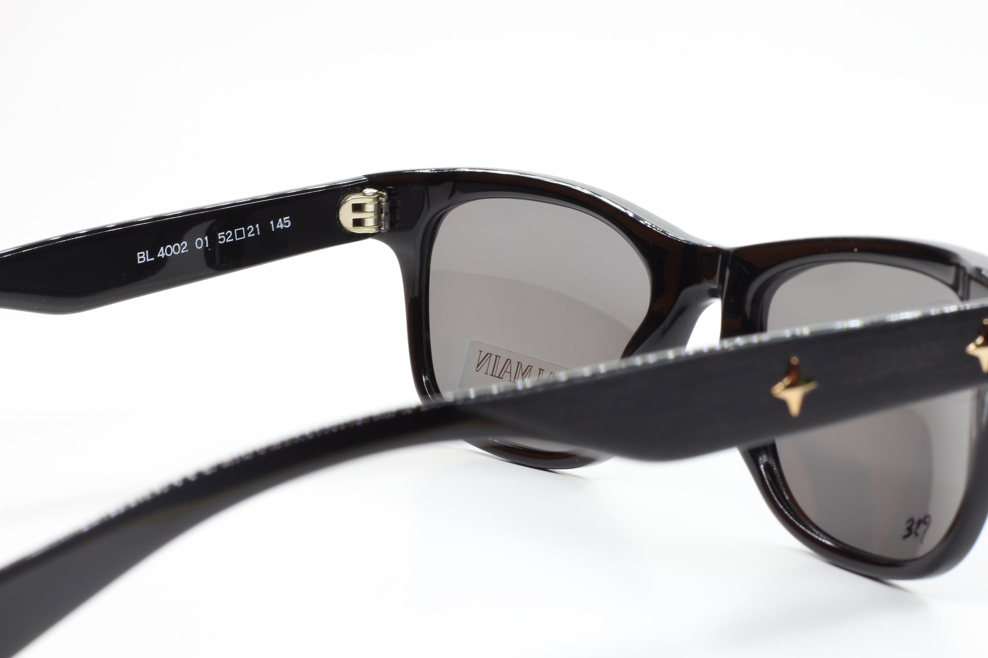 Close-up of Balmain BL4002 sunglasses with black frames and gray lenses by ABC Optical