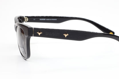 Side view of Balmain BL4002 sunglasses with black optical frames and gold logo accents