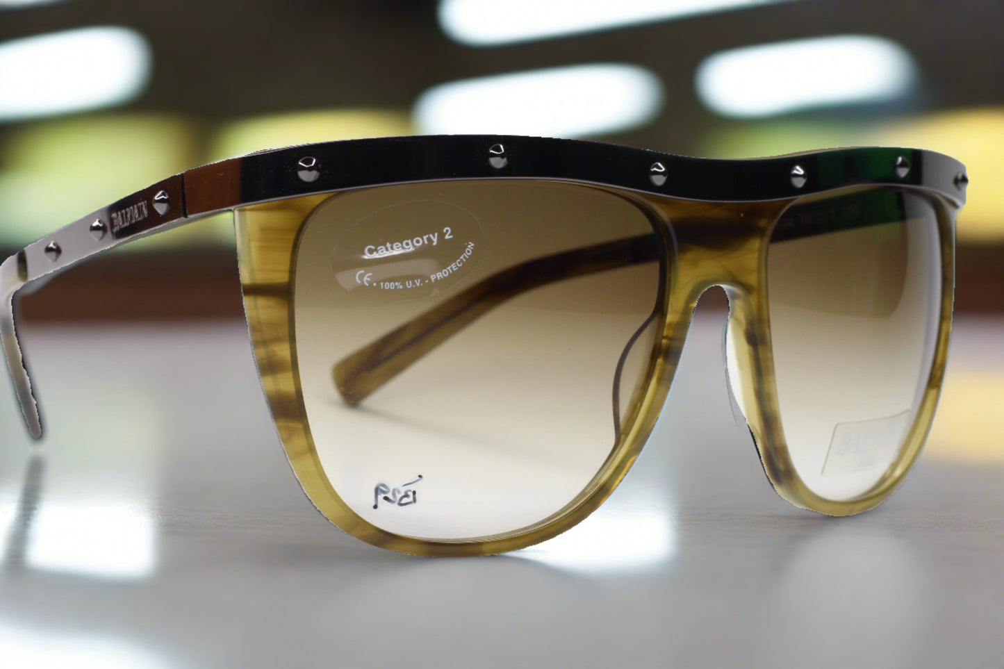 Balmain Paris khaki horn sunglasses with gradient lenses and studded top frame from ABC Optical