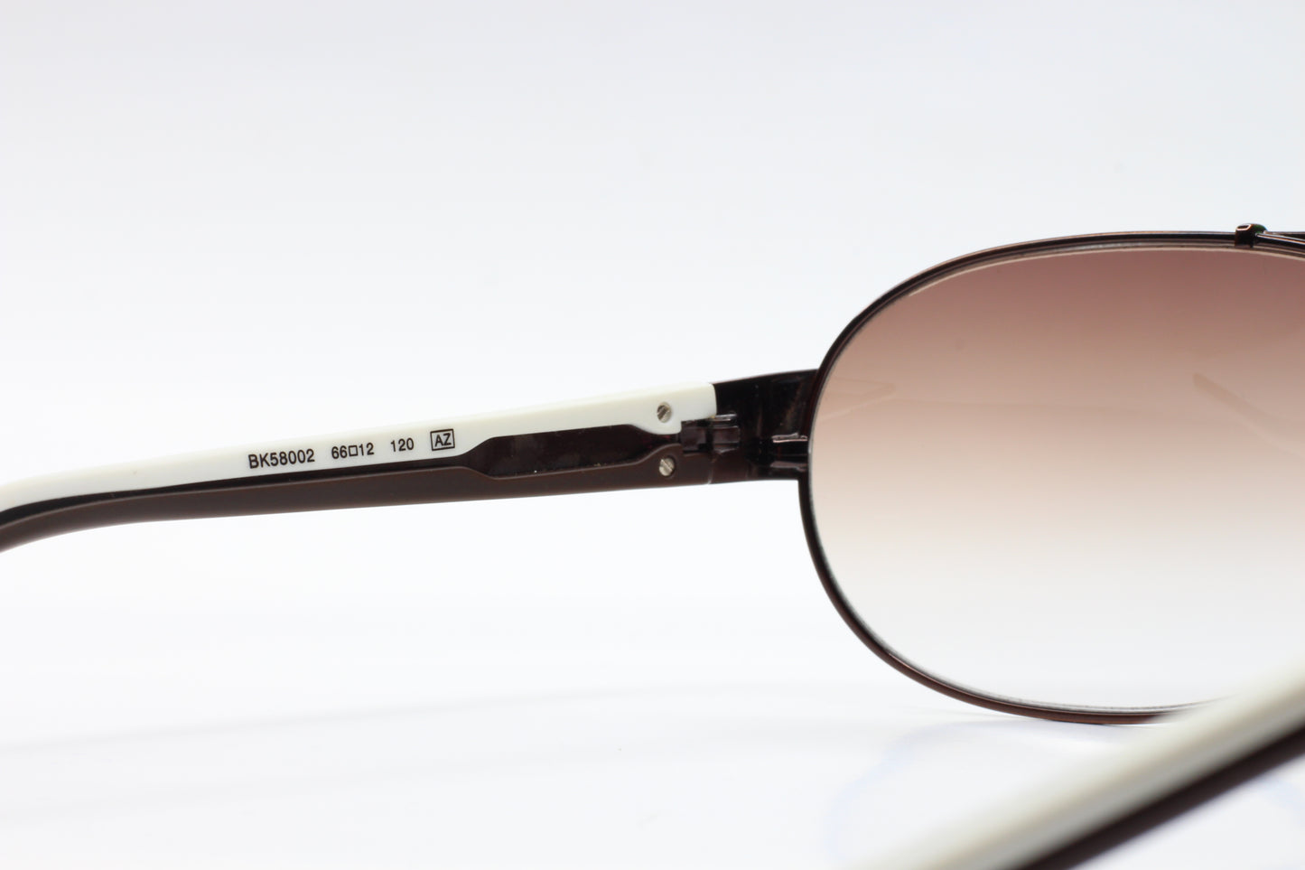 Close-up of ABC Optical BK58002 white aviator sunglasses temple and lens detail