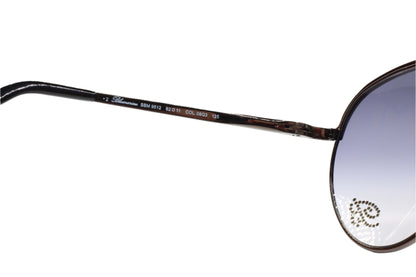 Close-up of Blumarine SBM9512 08Q3 sunglasses online with detailed frame branding by ABC Optical
