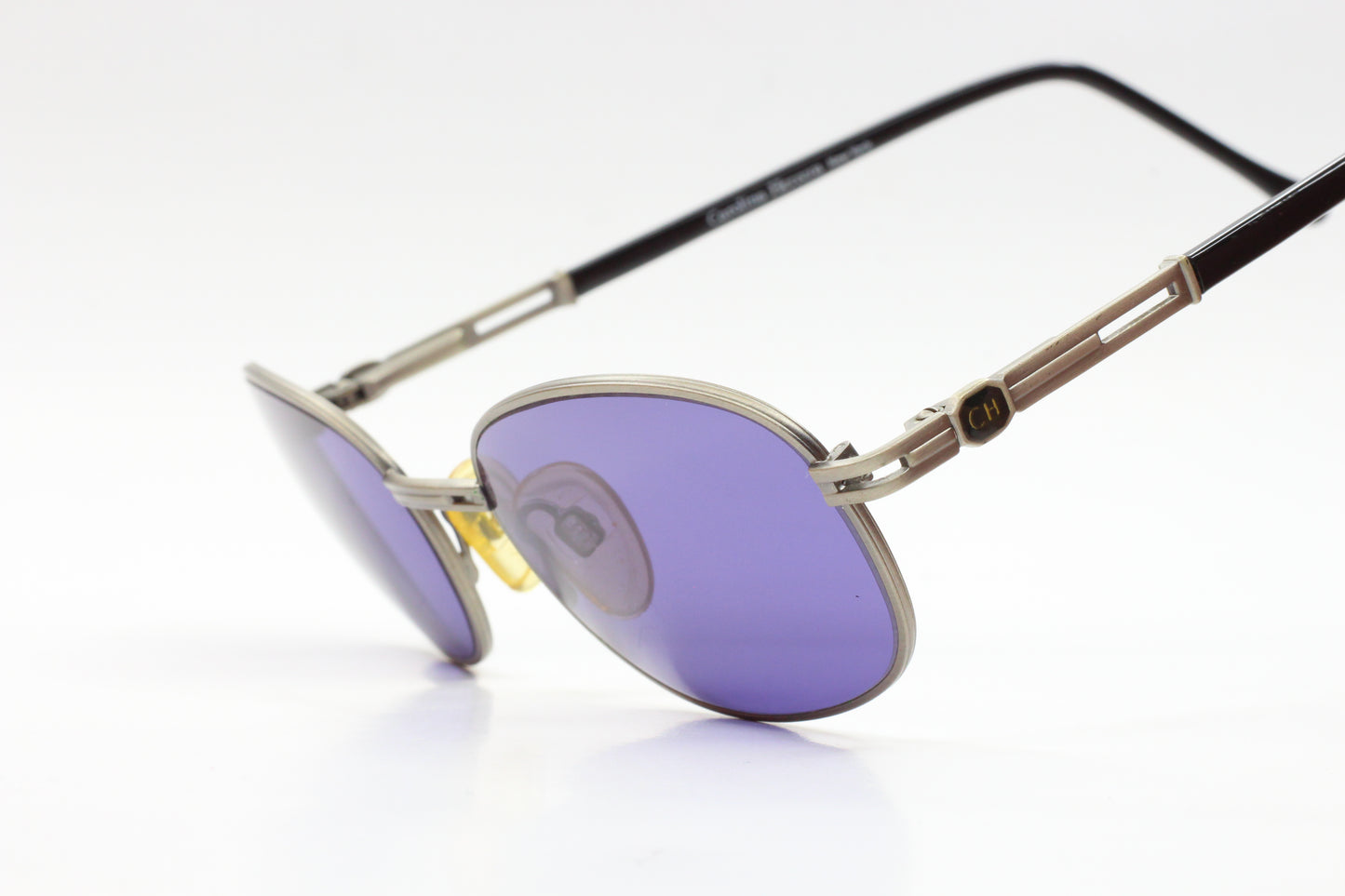 CH804 PD520 Carolina Herrera sunglasses with purple lenses and silver black frames by ABC Optical