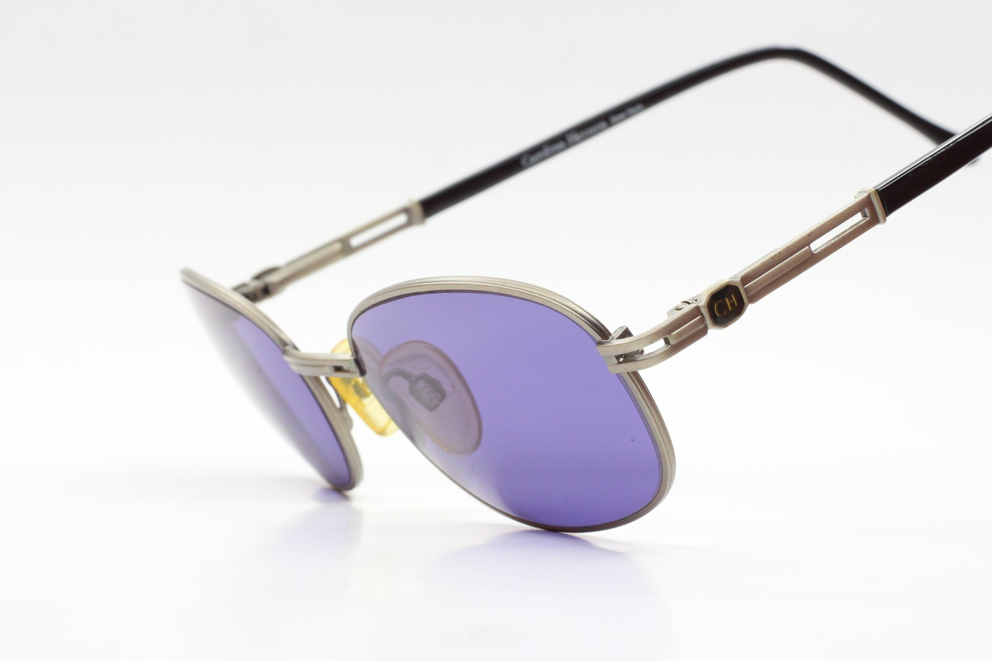 CH804 PD520 Carolina Herrera sunglasses with purple lenses and silver black frames by ABC Optical