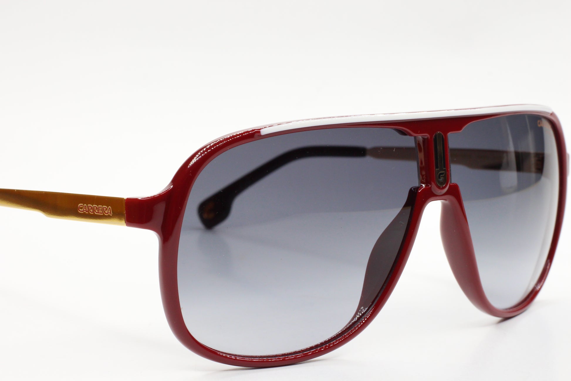 Red aviator style Carrera sunglasses by ABC Optical with tinted lenses and brown temple arms