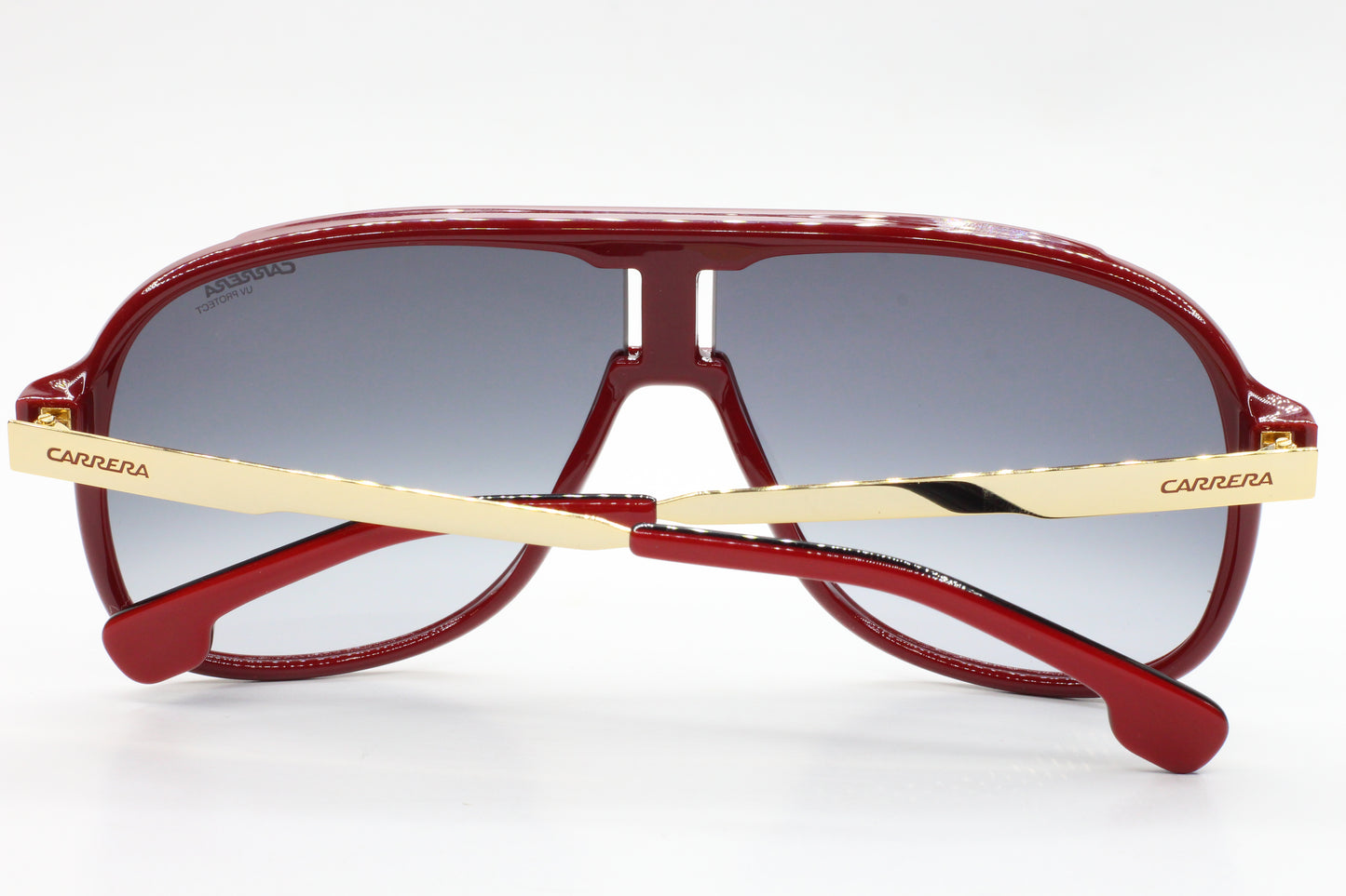 Red aviator style Carrera sunglasses with gold temples and gradient lenses by ABC Optical