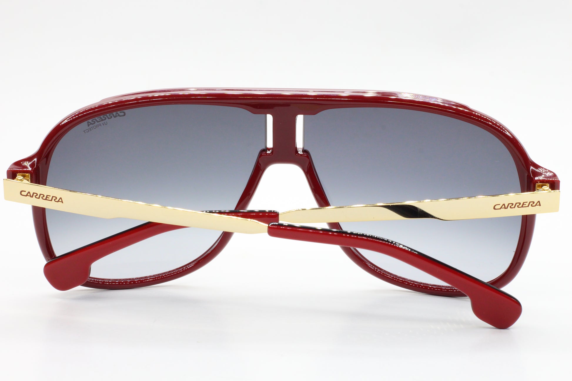 Red aviator style Carrera sunglasses with gold temples and gradient lenses by ABC Optical