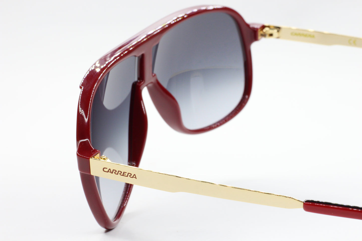 ABC Optical aviator style Carrera sunglasses with red frames and gold temples close-up