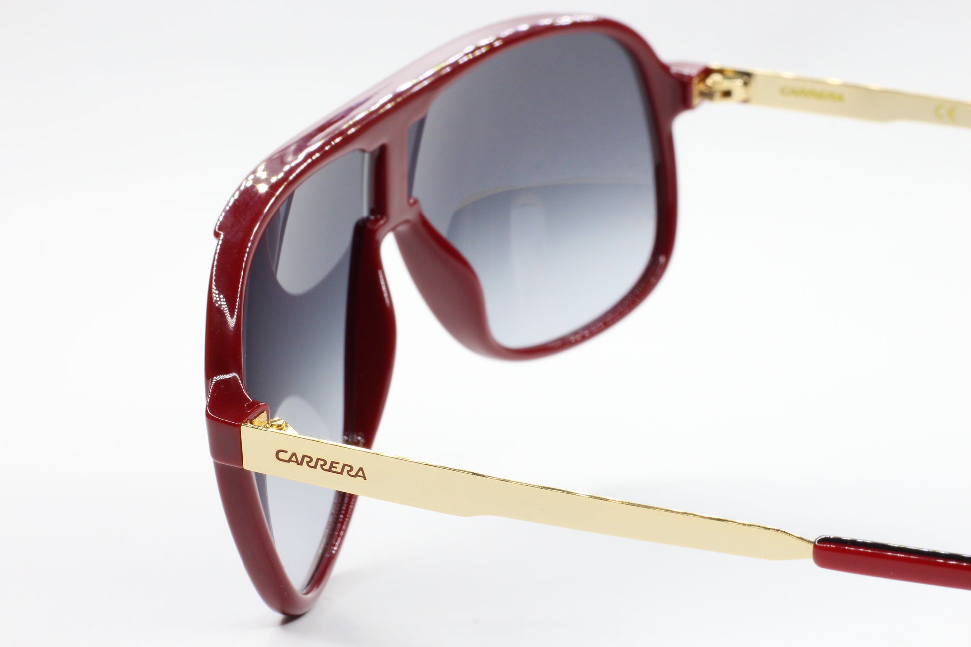 ABC Optical aviator style Carrera sunglasses with red frames and gold temples close-up