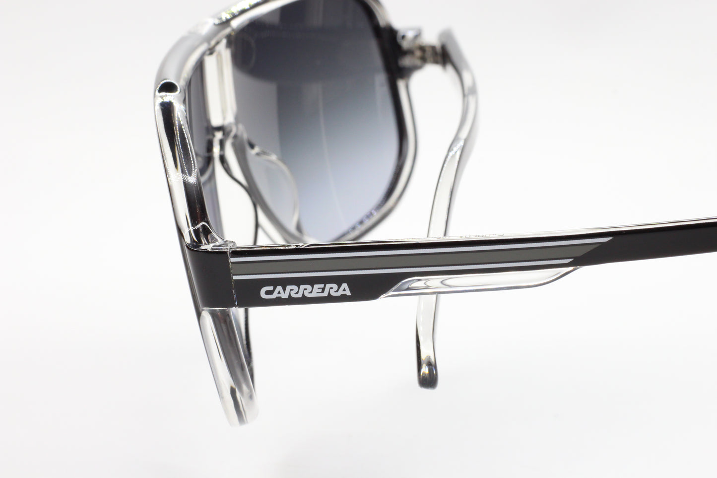 Close-up of Carrera designer shades with black and clear optical frames to buy Carrera designer shades online