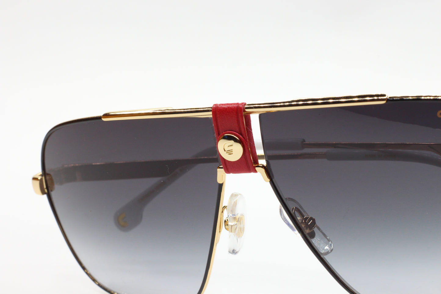 Close-up of ABC Optical Carrera sunglasses with gold frame and dark lenses to buy Carrera sunglasses online