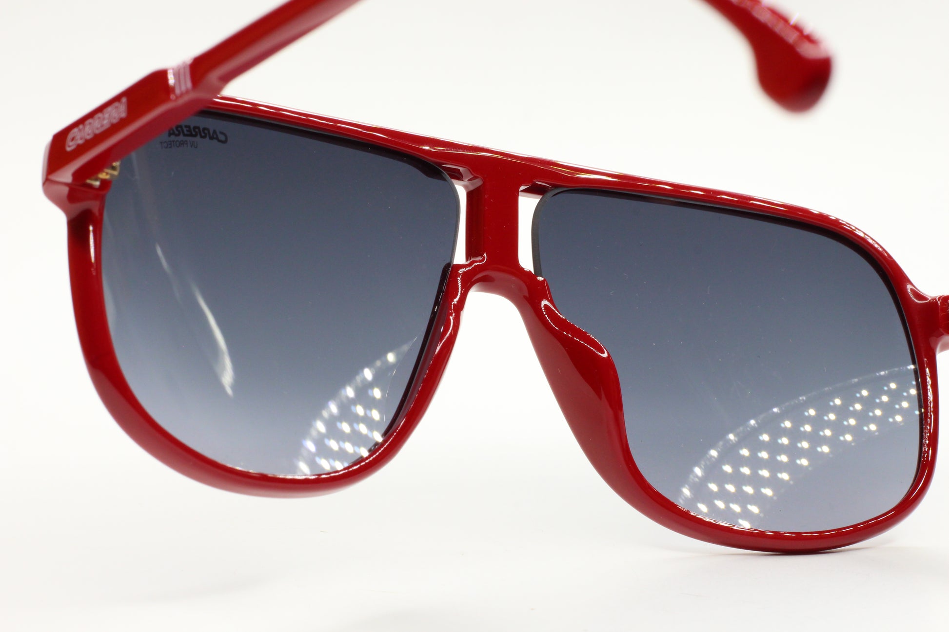 Close-up of red optical frames Carrera men's fashion eyewear with blue gradient lenses by ABC Optical