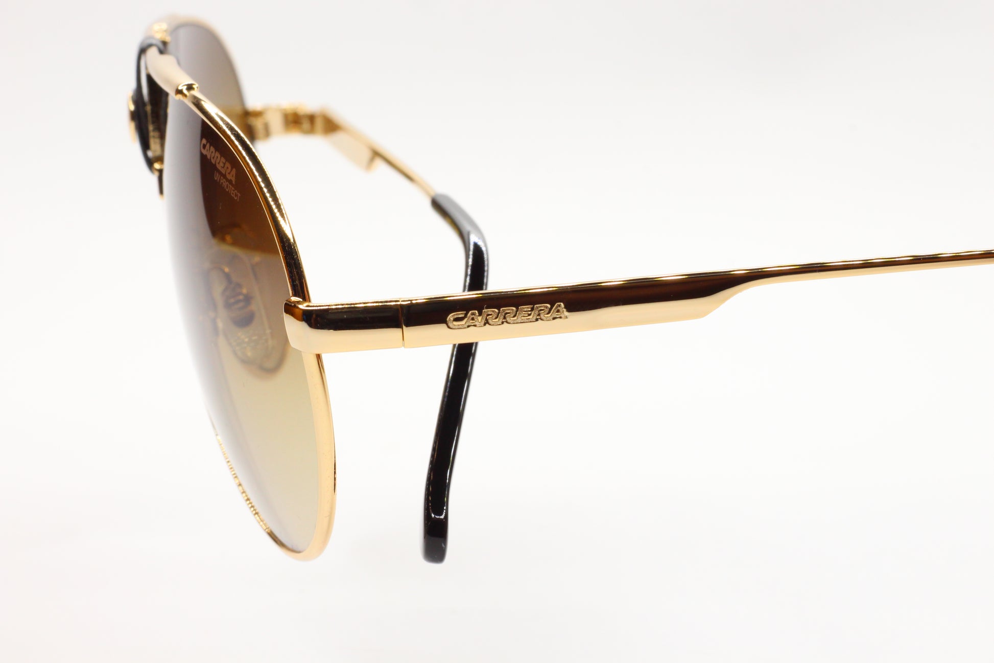 ABC Optical premium Italian sunglasses online with gold frame and tinted lenses close-up