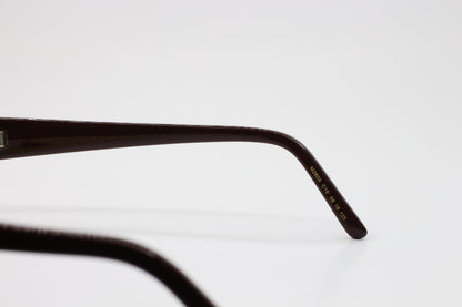 Close-up view of ABC Optical Caviar M2608 gold brown sunglasses temple arm with model details