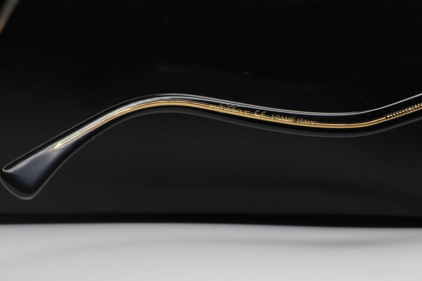 Close-up side view of ABC Optical Caviar M3002 Swarovski sunglasses frame arm with gold detailing