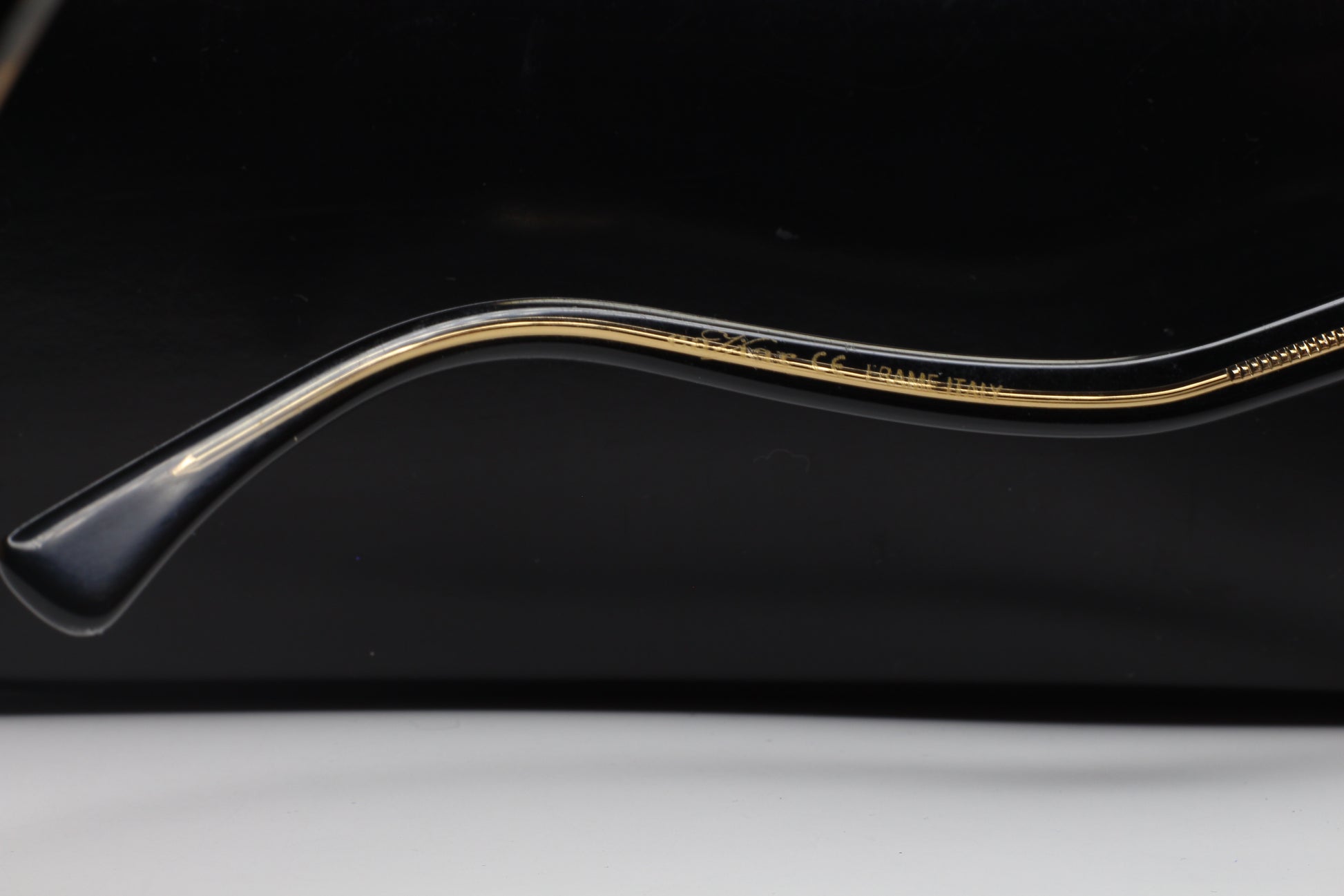 Close-up side view of ABC Optical Caviar M3002 Swarovski sunglasses frame arm with gold detailing