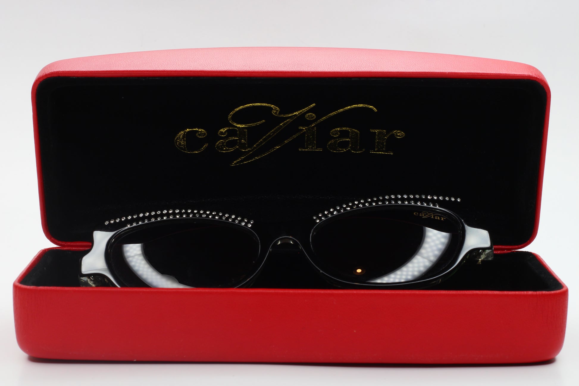 Caviar M3002 Swarovski sunglasses in black displayed inside a red ABC Optical case