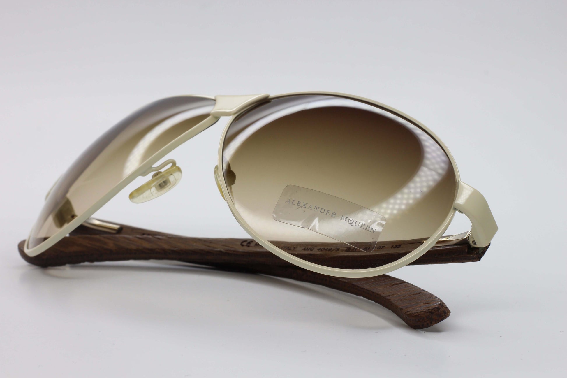 Gold and brown designer Alexander McQueen AMQ4049S eyewear with gradient lenses and wooden temple tips