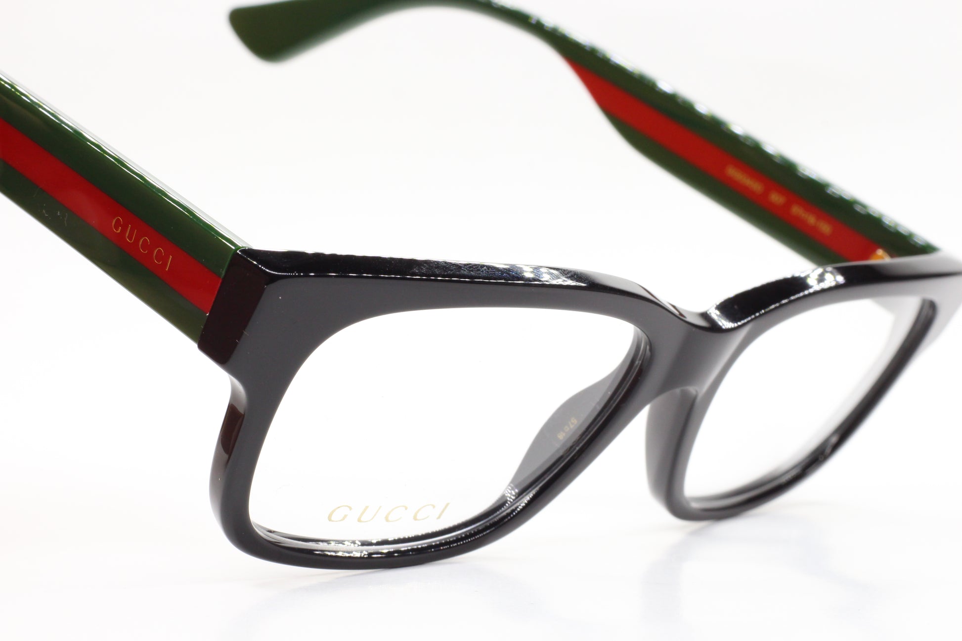 Gucci GG0343O 007 eyeglasses for sale featuring black rectangular frames with green and red striped temples