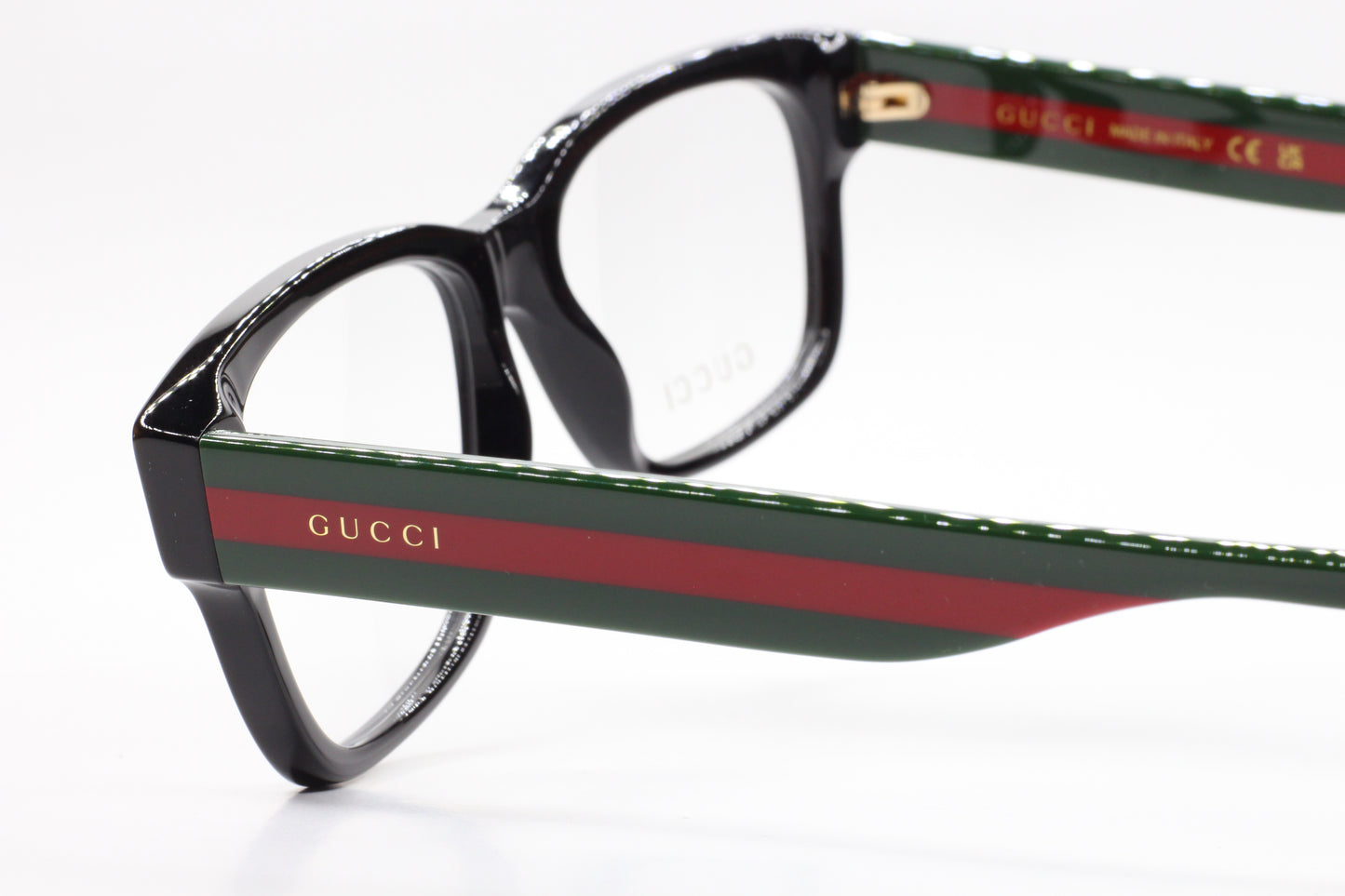 Gucci GG0343O 007 eyeglasses for sale featuring black frames with green and red striped temples by ABC Optical