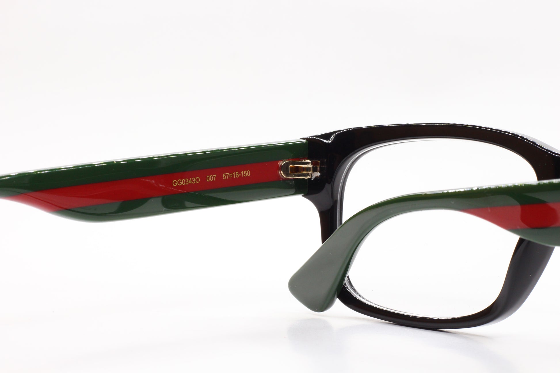 Gucci GG0343O 007 eyeglasses for sale featuring black and green optical frames by ABC Optical