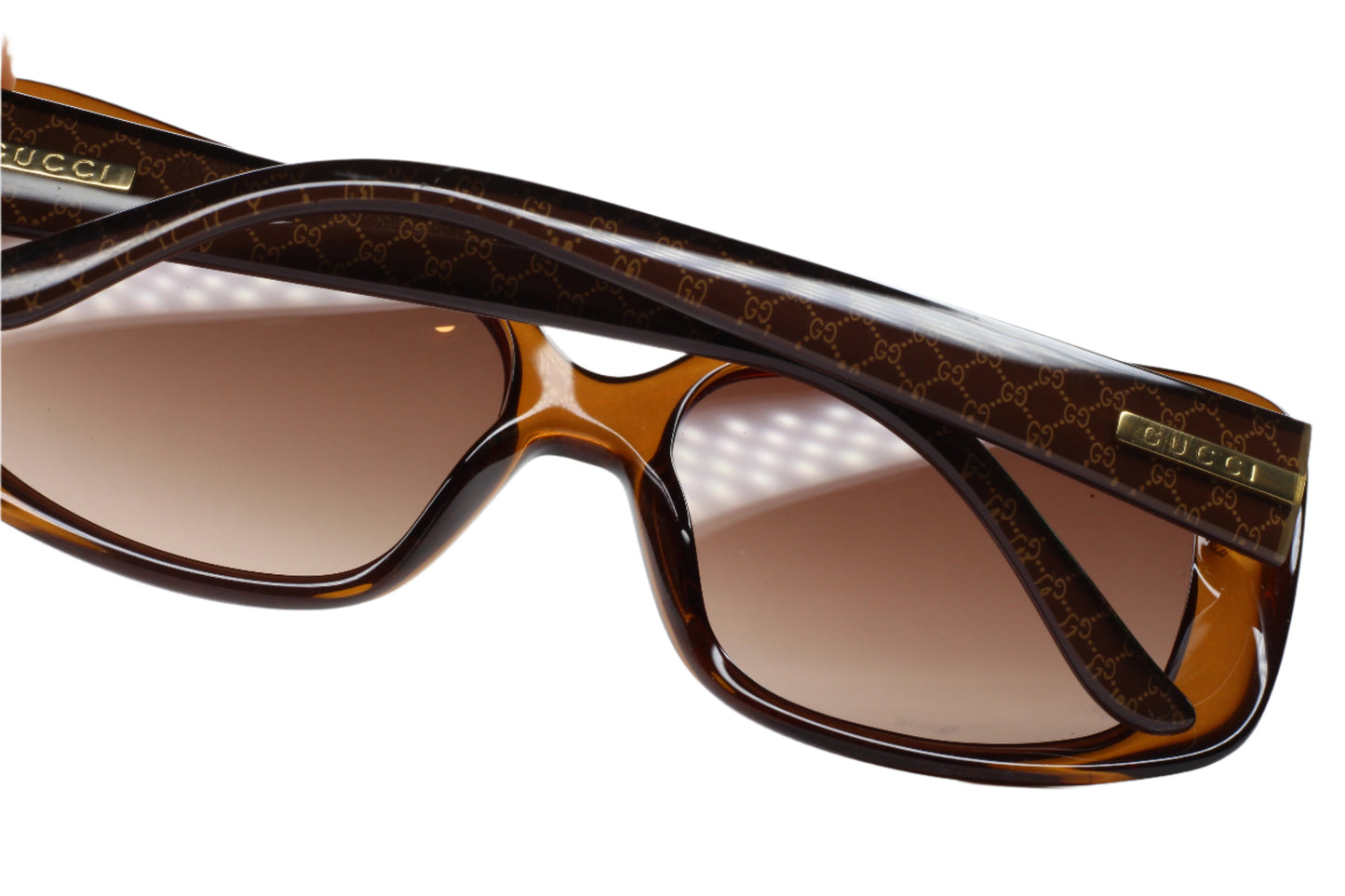 Close-up of Gucci GG3577S sunglasses for women with brown gradient lenses and designer frame pattern