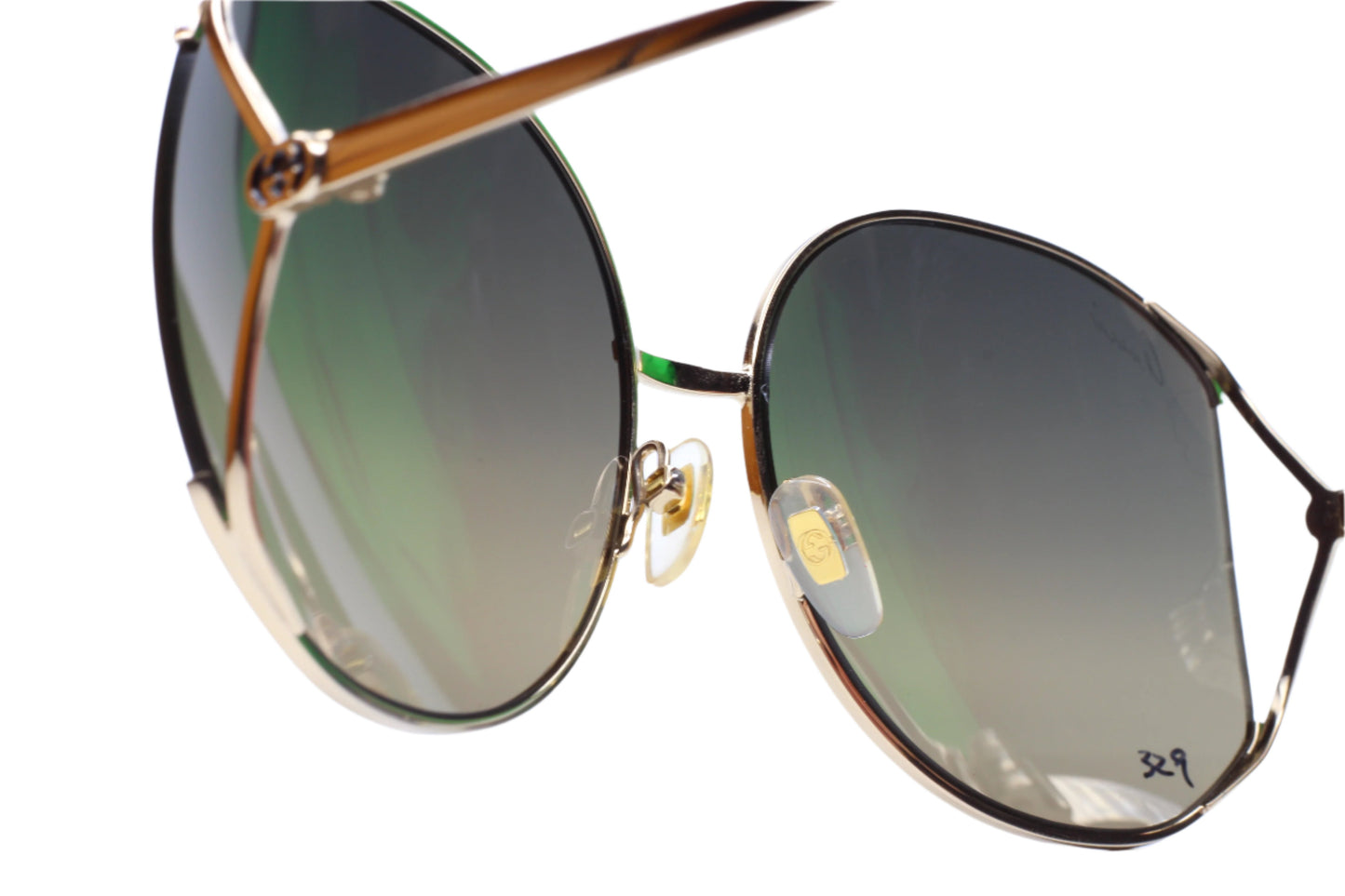 Gucci gold metal sunglasses women with gradient lenses and thin metal frames by ABC Optical