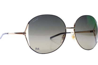 Gucci gold metal sunglasses women with round gradient lenses and thin gold frames by ABC Optical