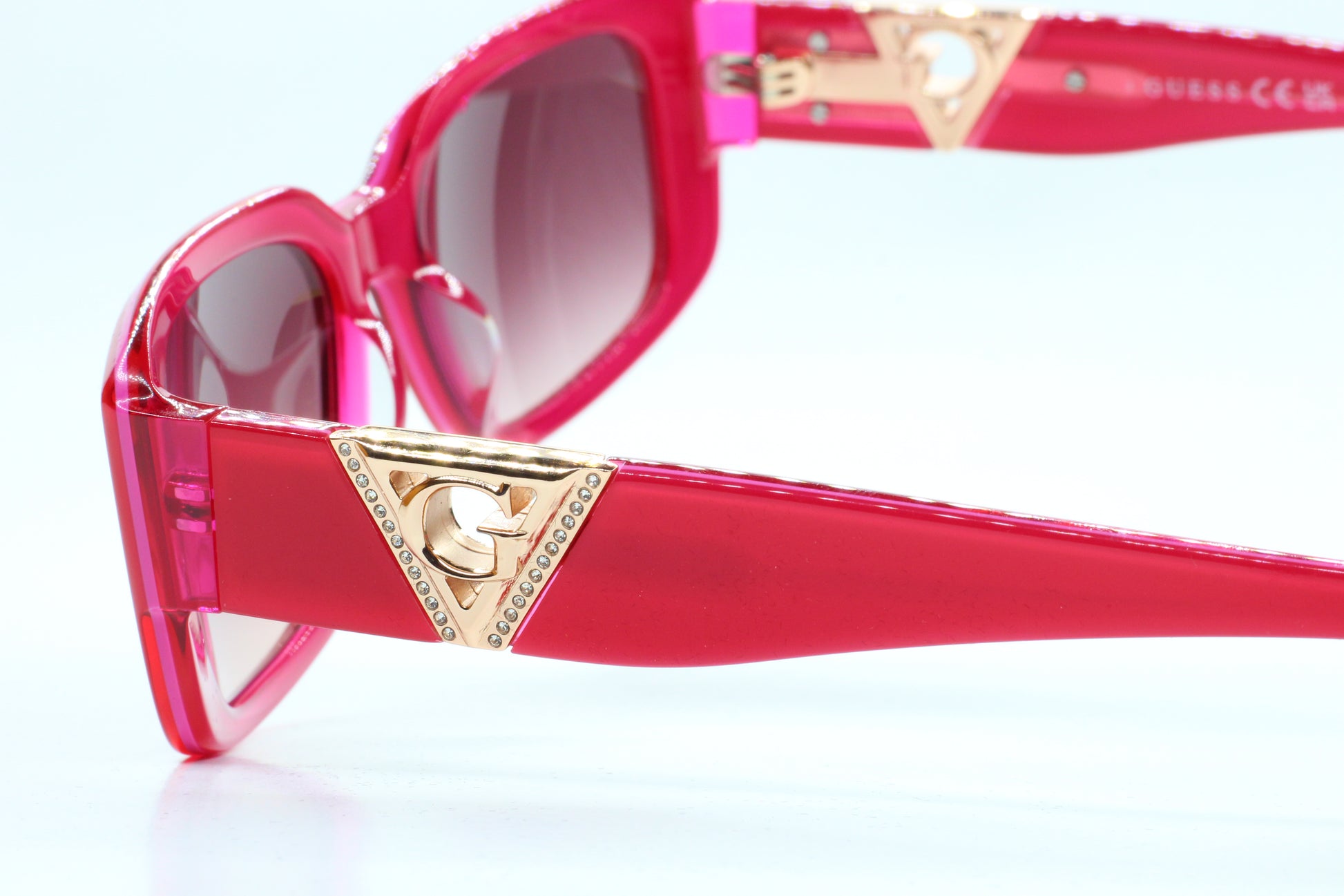 Guess pink gold sunglasses women with pink frames and gold triangle logo accents by ABC Optical