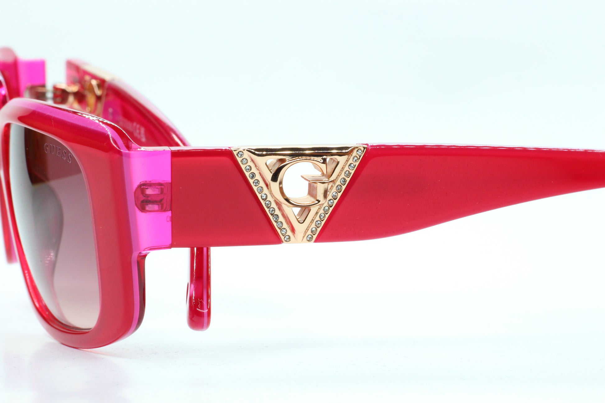 Guess pink gold sunglasses women in vibrant pink frame with gold logo detail from ABC Optical