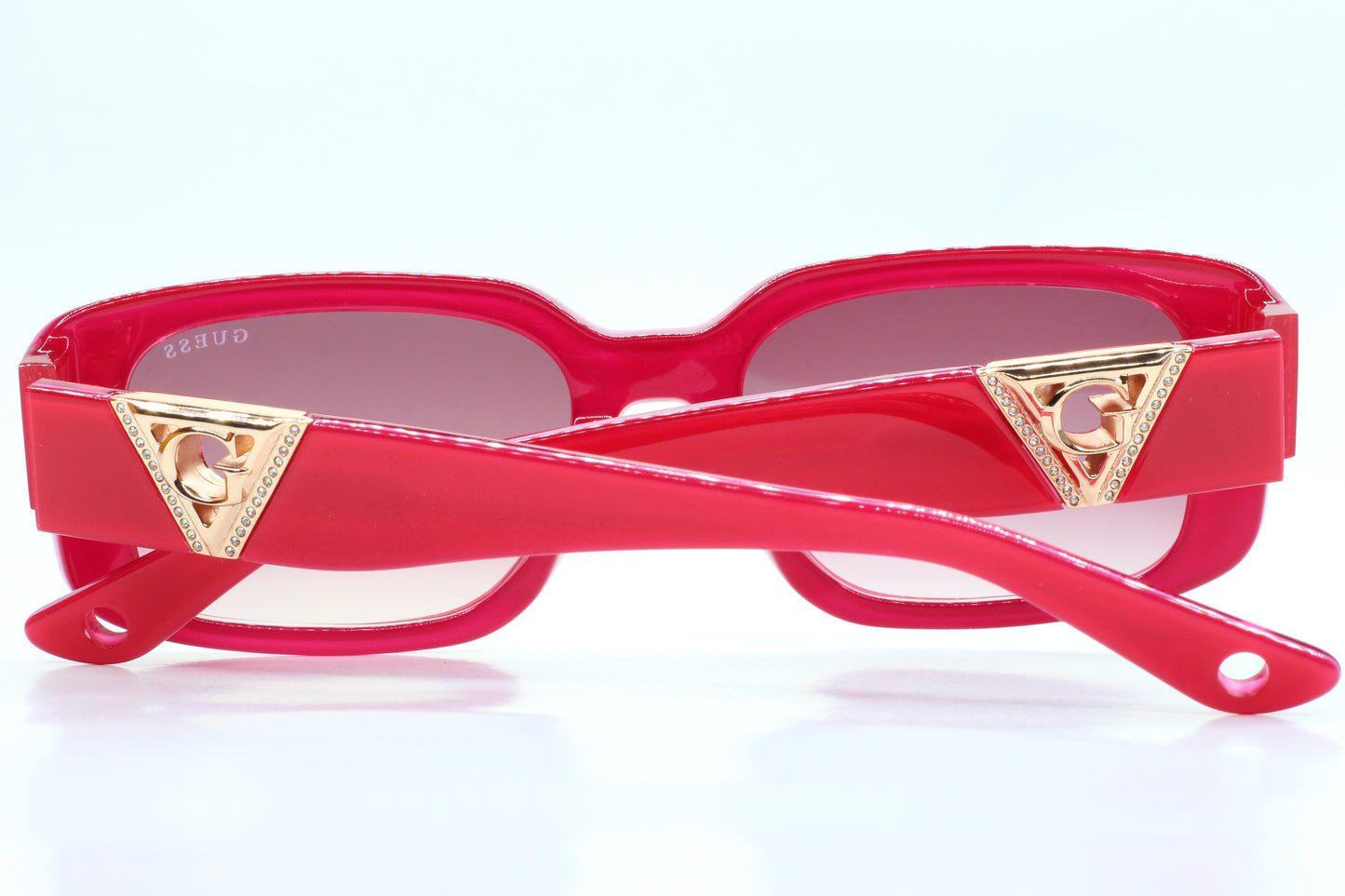 Guess pink gold sunglasses women by ABC Optical with pink frames and gold triangle accents