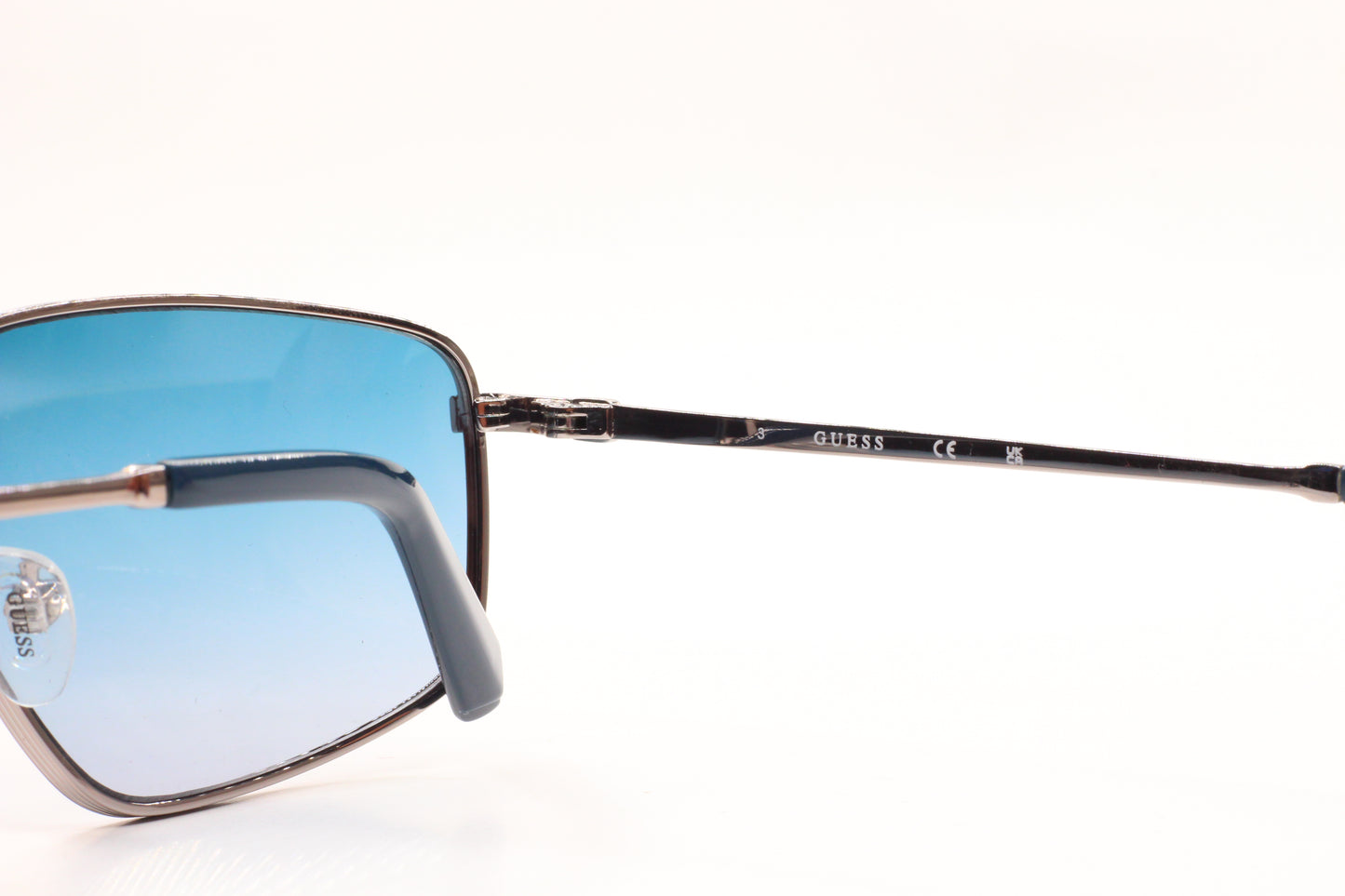 Guess silver blue gradient sunglasses from ABC Optical featuring sleek metal frames and stylish blue tinted lenses
