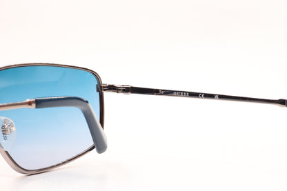 Guess silver blue gradient sunglasses from ABC Optical featuring sleek metal frames and stylish blue tinted lenses