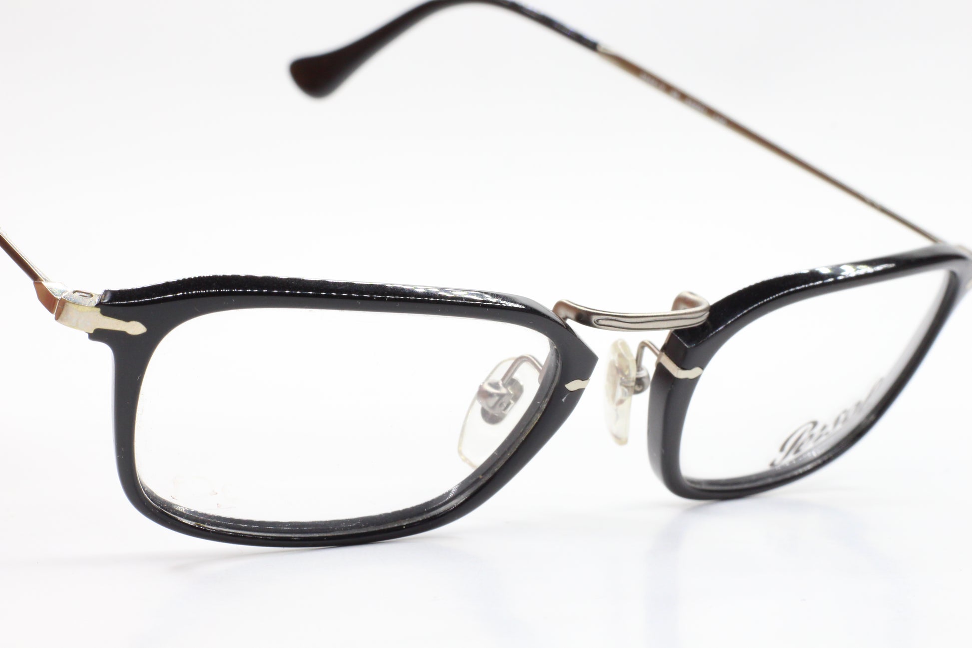 Black Persol PO3044V eyeglasses with metal bridge and adjustable nose pads by ABC Optical