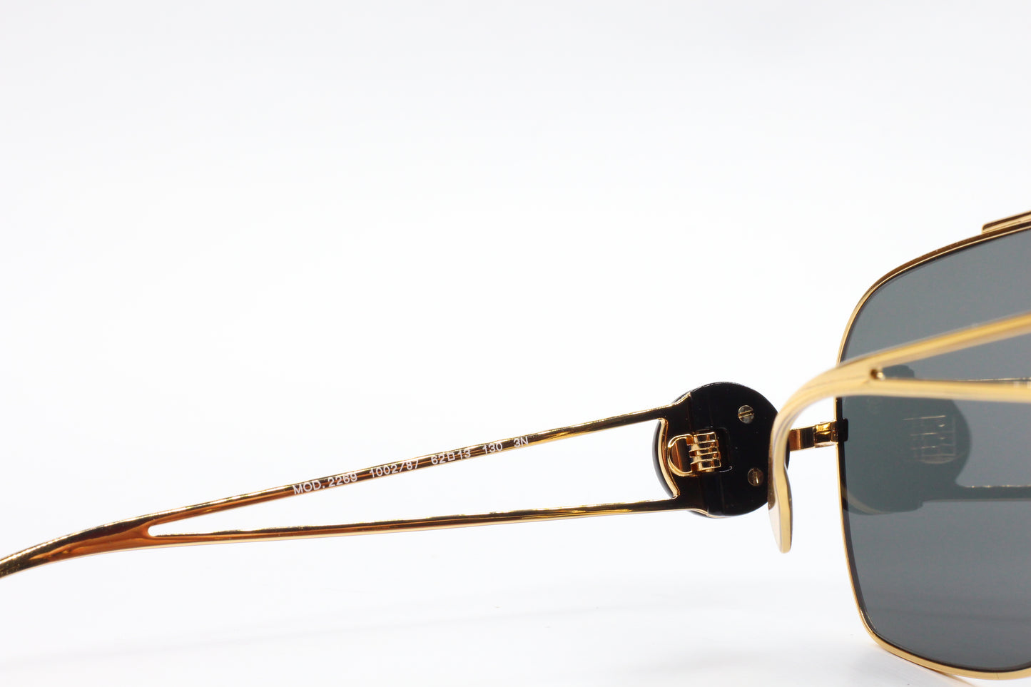 Close-up of ABC Optical luxury Italian designer sunglasses gold frame and dark lenses