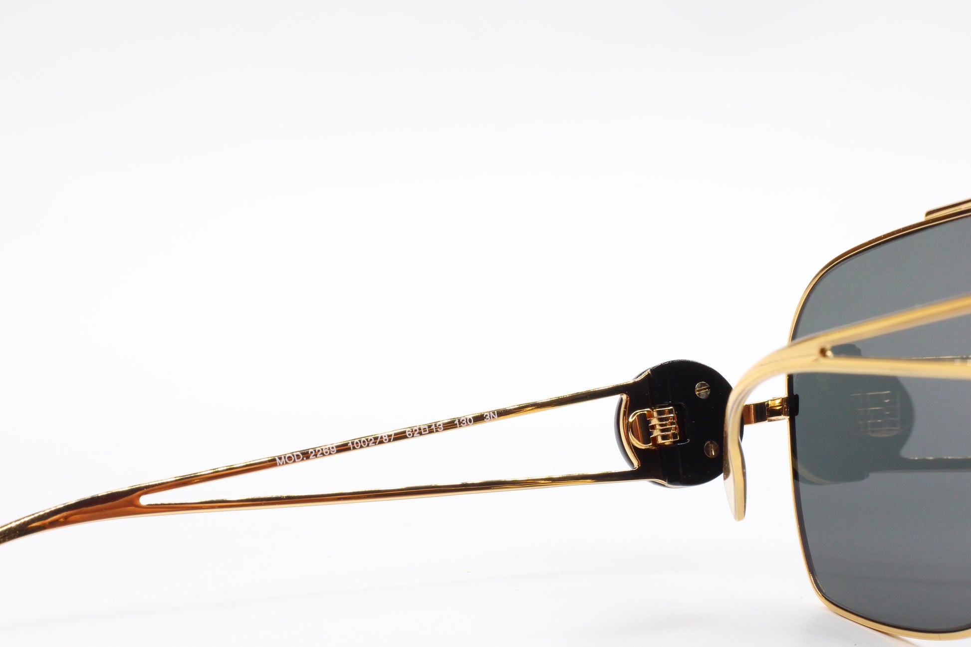 Close-up of ABC Optical luxury Italian designer sunglasses gold frame and dark lenses