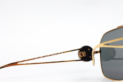Close-up of ABC Optical luxury Italian designer sunglasses gold frame and dark lenses