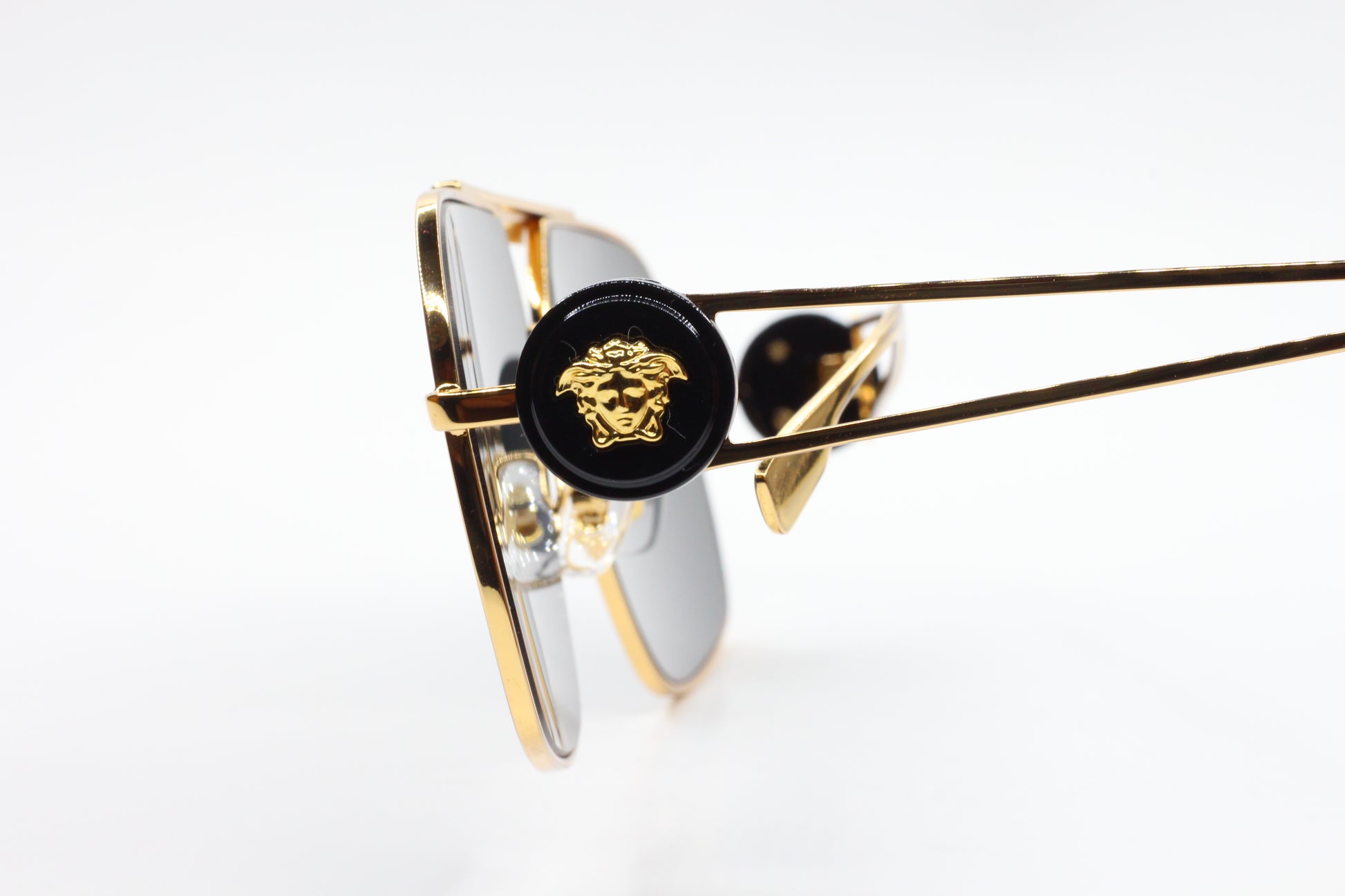 Luxury Italian designer sunglasses by ABC Optical with gold frame and detailed side emblem