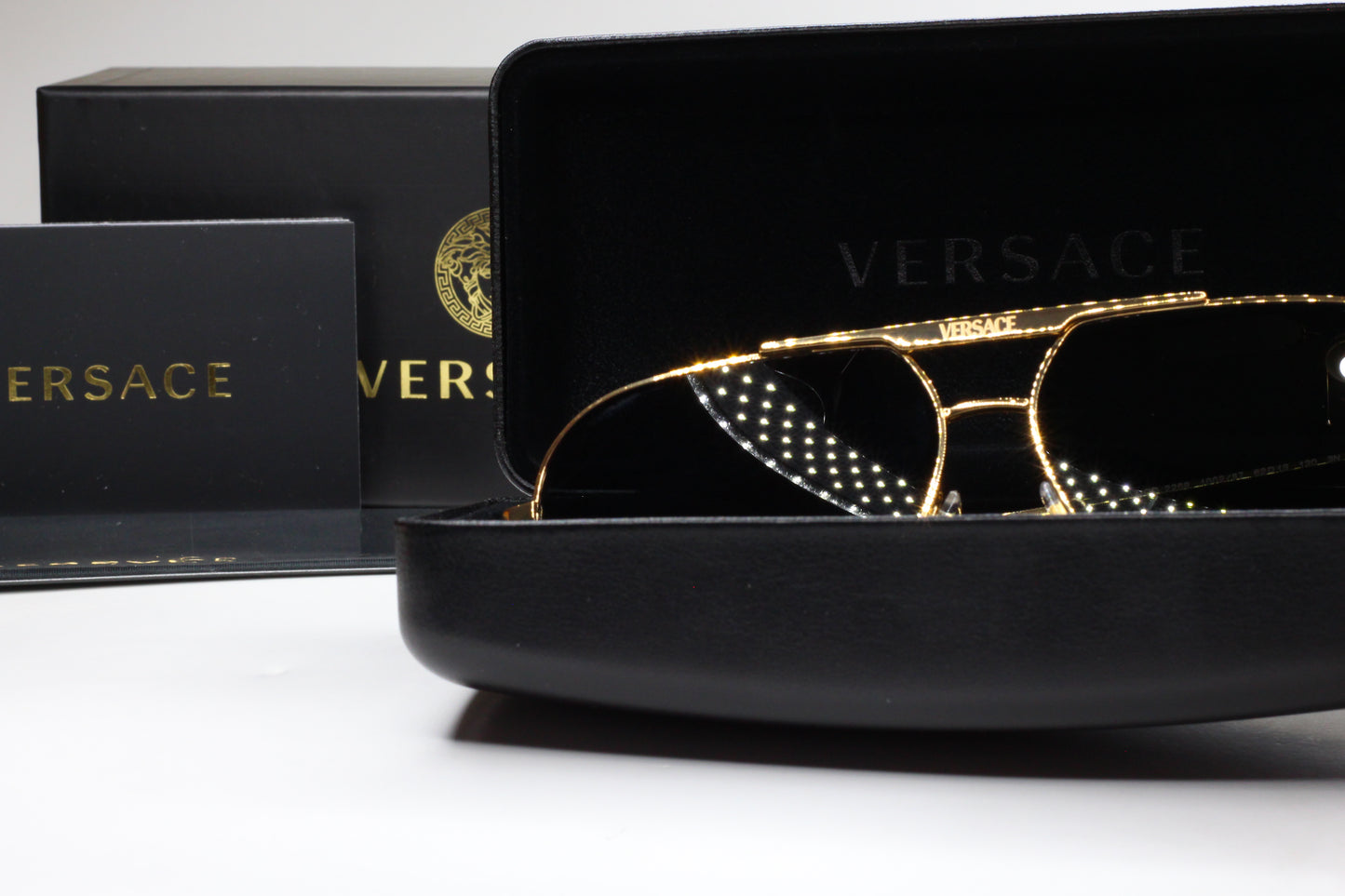 Luxury Italian designer sunglasses by ABC Optical in gold frame with Versace branding and black case