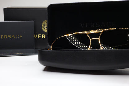 Luxury Italian designer sunglasses by ABC Optical in gold frame with Versace branding and black case